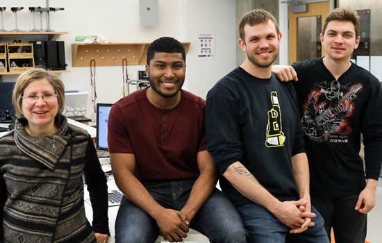 Professor Lisa Shatz in the lab with student teammates Christopher Villar, Justin Bassett, and Roman Deyak, whose solar power project won second place in the Cuba Infrastructure Scholarship Competition