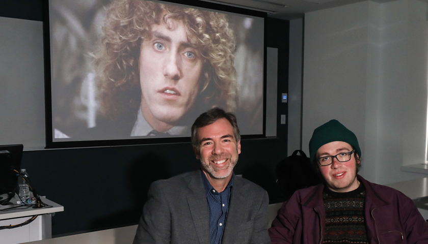 The face of The Who's Roger Daltrey is projected on a screen behind  Quentin Miller and Caleb Elfland