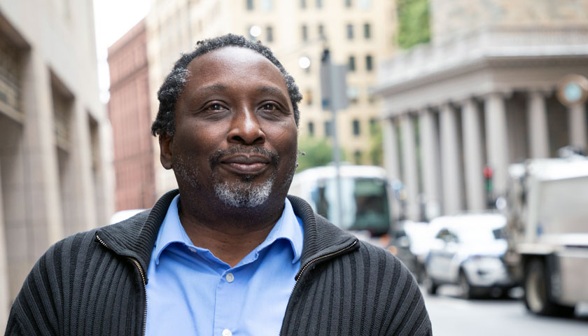 Professor Robert Bellinger in front of 73 Tremont Street