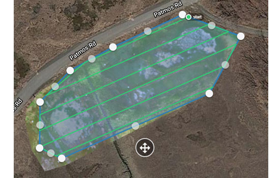 Parallel lines overlaid on marsh photo indicate flight pattern