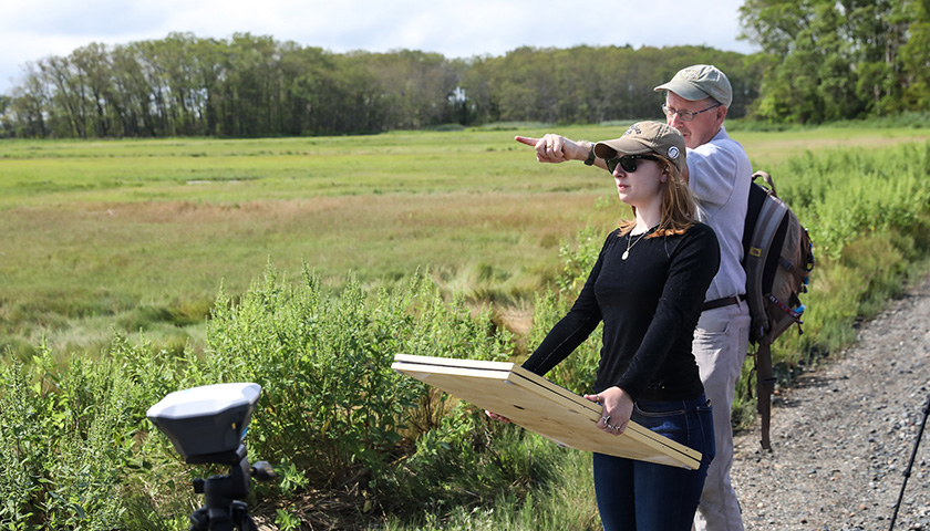 Student lugs targets to marsh