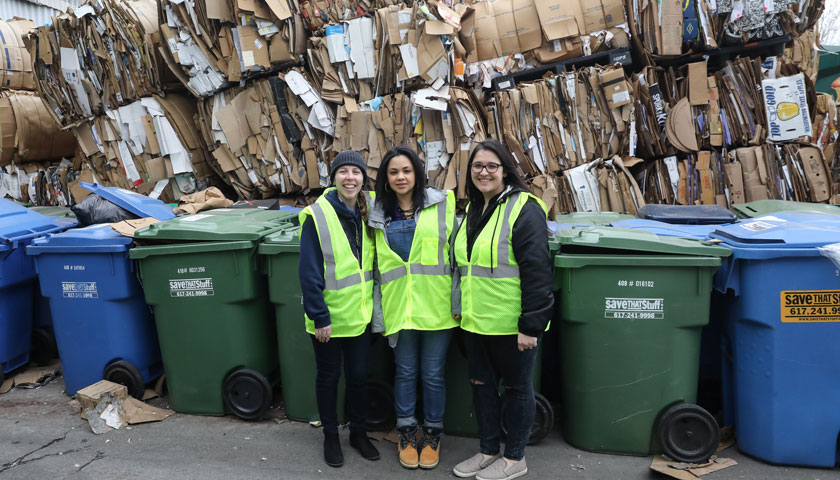 staff members tour recycling facility