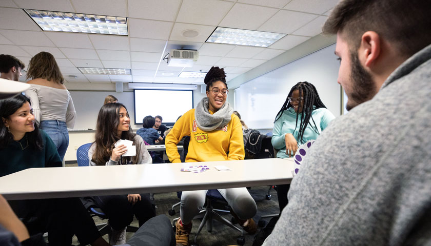 Students laugh while playing game in class