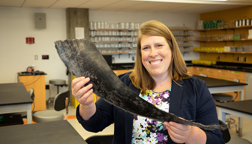 Nadine Lysiak in lab holding baleen plate