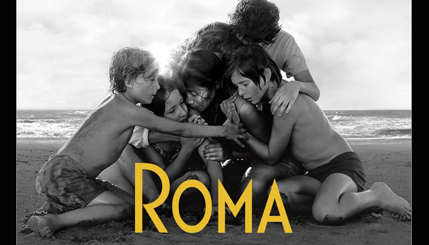 Poster for Roma film shows family huddled on beach