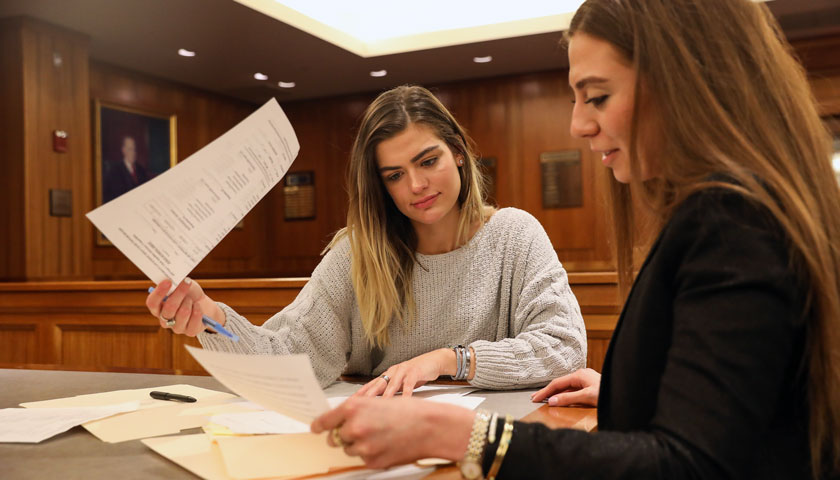 Julianne and Shai look at case files