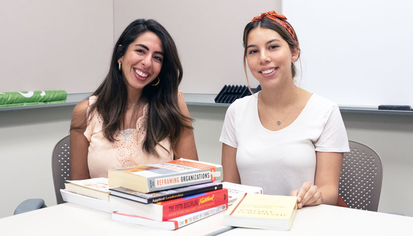 Anastasia Moawde and Sara Miranda with collected books