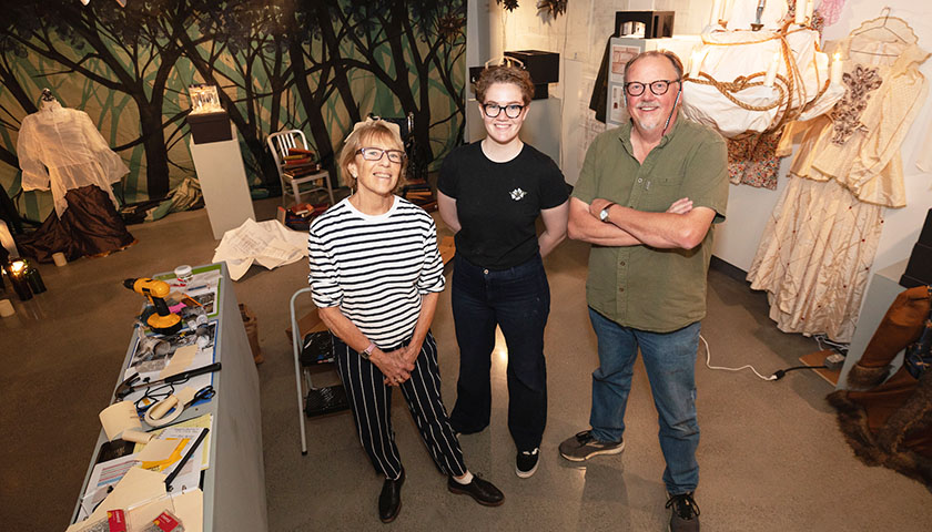 Deborah Davidson, Micaleen Rogers and Richard Chambers pose in the middle of the gallery during exhibit installation