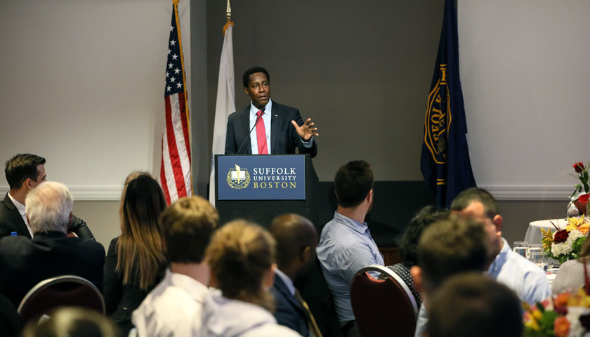 Setti Warren speaks at podium