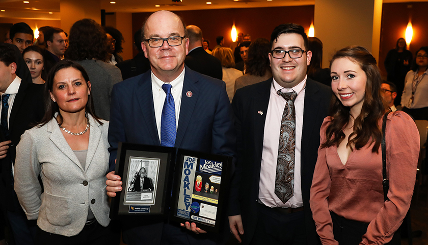 Congressman Jim McGovern holds gift from Suffolk group