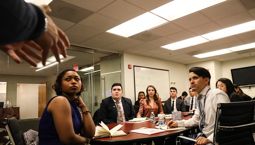Hands of lobbyist gesture as students listen