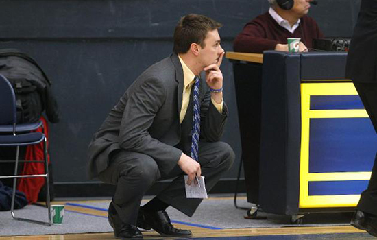 Jeff Juron crouched along sidelines focusing on  game