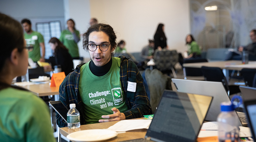 Students in Hackathon T-shirts discussing ideas 