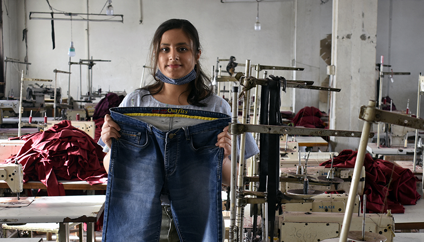 Aashi Sethi holds a pair of blue jeans