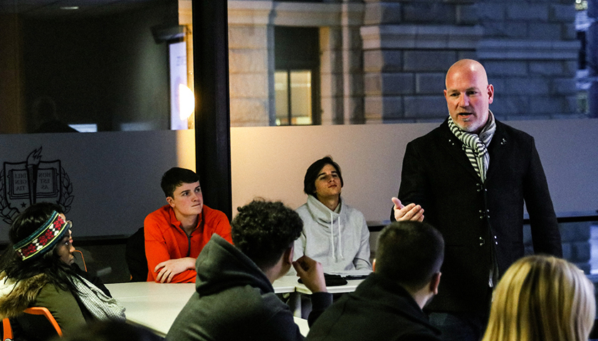 Professor Stephan Thieringer teaching students gathered around a table