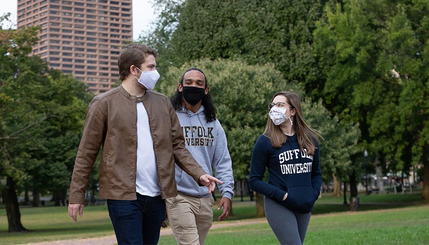 Suffolk students with masks on walk on the Common
