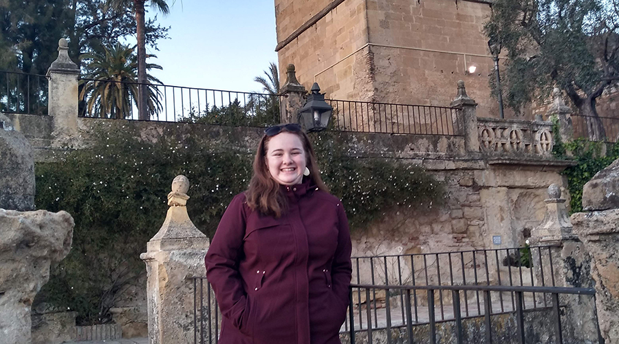 Mikayla Hopkins in front of castle turret in Cordoba