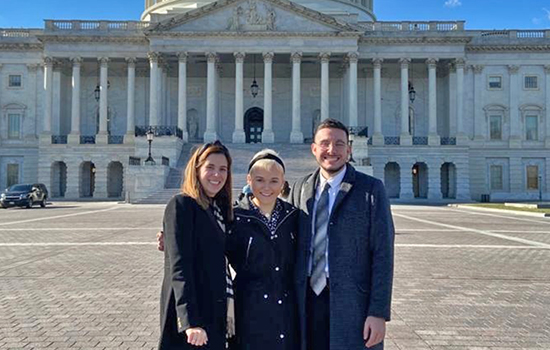 Three students in front of Capitol building