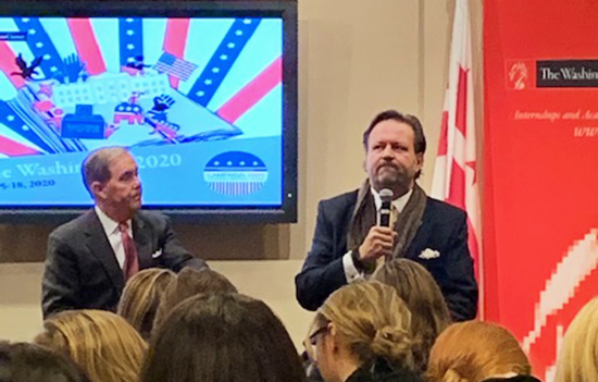 two men, one with microphone, in Washington Center auditorium