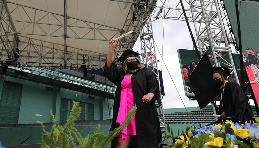 A newly minted SBS graduate at the 2020 Commencement ceremony