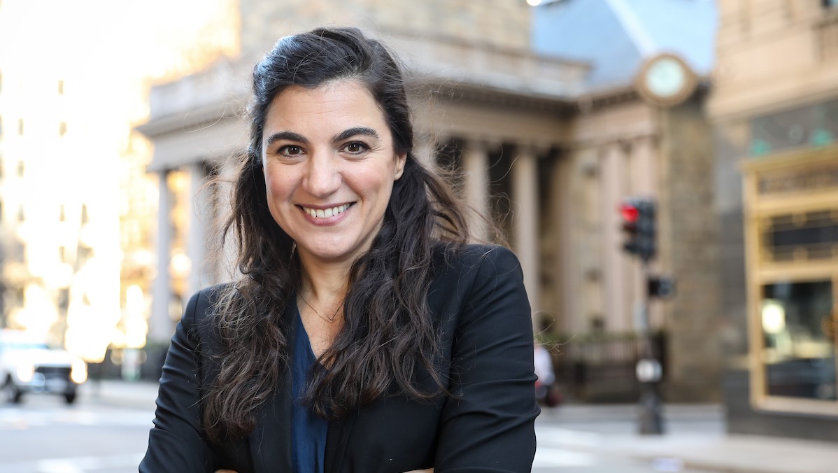 Professor Elena Llaudet stands outside in Boston