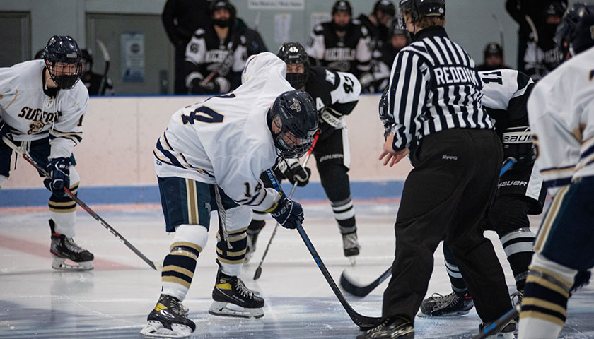 Suffolk ice hockey player waits for a referee to drop the puck