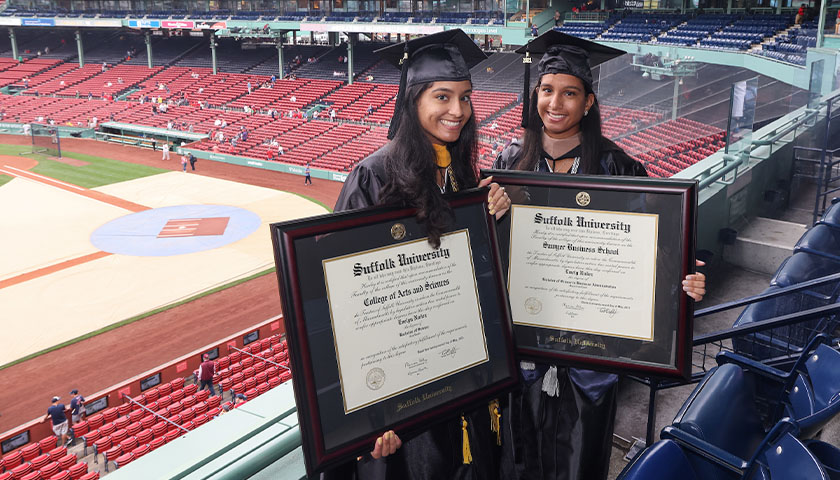 Evelyn and Emely Nunez hold their framed diplomas following their special Commencement ceremony at Fenway Park on September 18, 2021