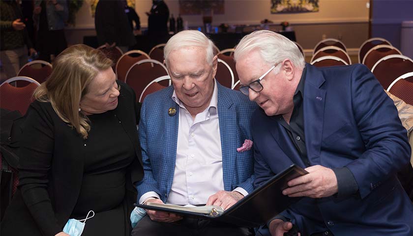 Ed McDonnell and two of his children review the thank-you notes from McDonnell scholars