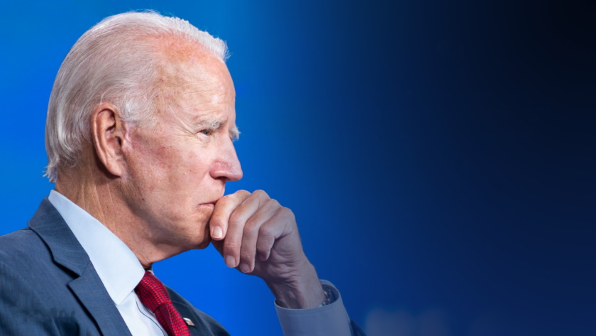 President Biden in profile against a blue background