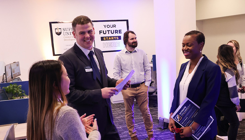 Dave Merry chats with attendees of the opening of the new Career Center space