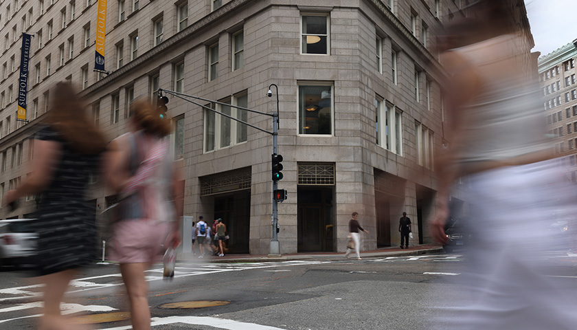 A picture of the corner of 73 Tremont from the busy intersection of Tremont and Beacon Streets.