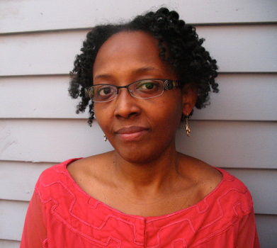 Headshot of Marjorie Salvodon in a red shirt and glasses