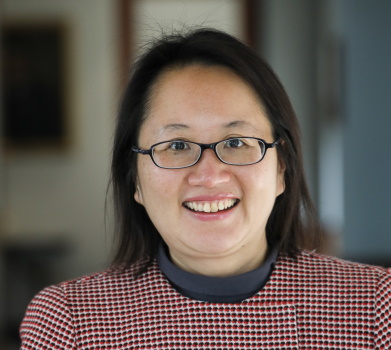 Headshot of Micky Lee smiling wearing glasses