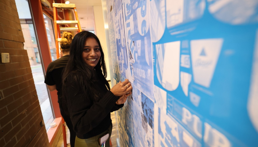 Graduate student Shreyanshi Satodia works on the exhibit installation