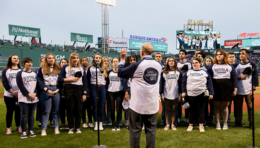 Suffolk students sing the National Anthem at Fenway Park