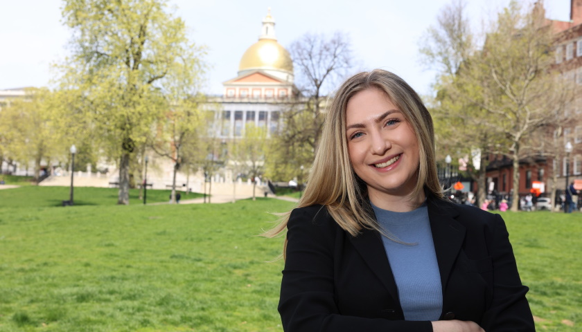 Mikaela Linder stands outside the MA State House