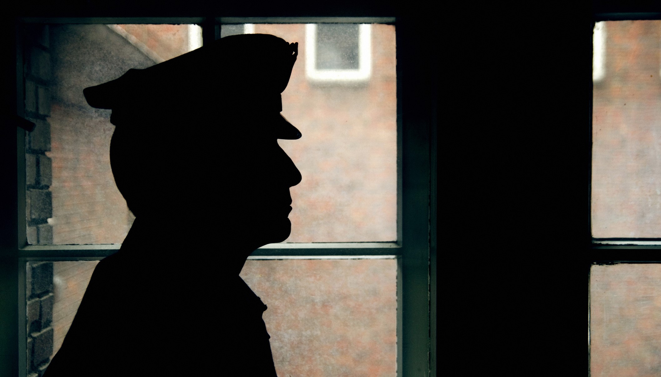 Silhouette of officer against a window