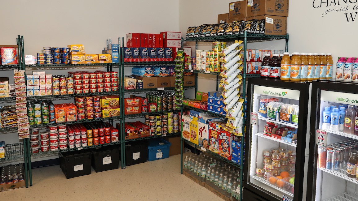 The Suffolk CARES pantry, stocked with shelves of canned and packaged food, refrigerated food and drinks, and other essential items