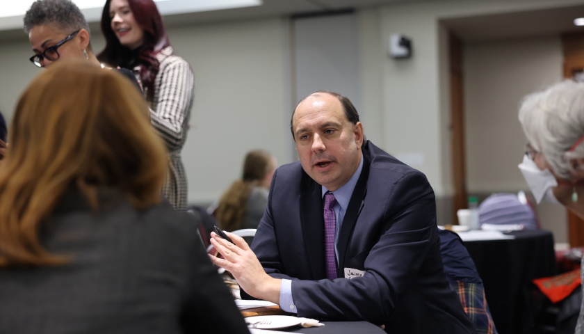 Massachusetts State Senator Jamie Eldridge, seated, speaks with attendees at the Decarcerating Women Today: Charting a Path conference