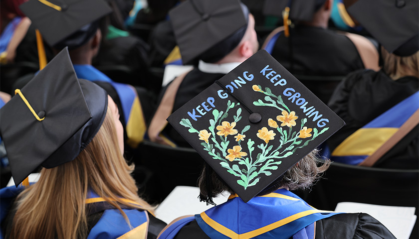 Colorful mortarboard at the 2023 Sawyer Business School Commencement