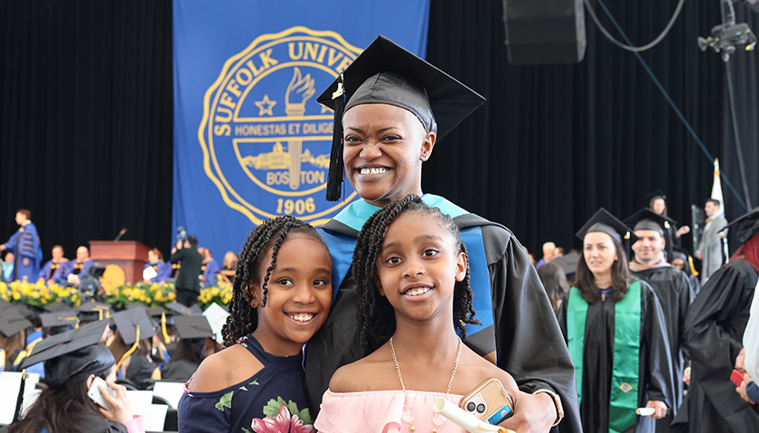 Dr. Fatima Watt,the 2023 Sawyer Business School Commencement graduate student speaker, with her two daughters