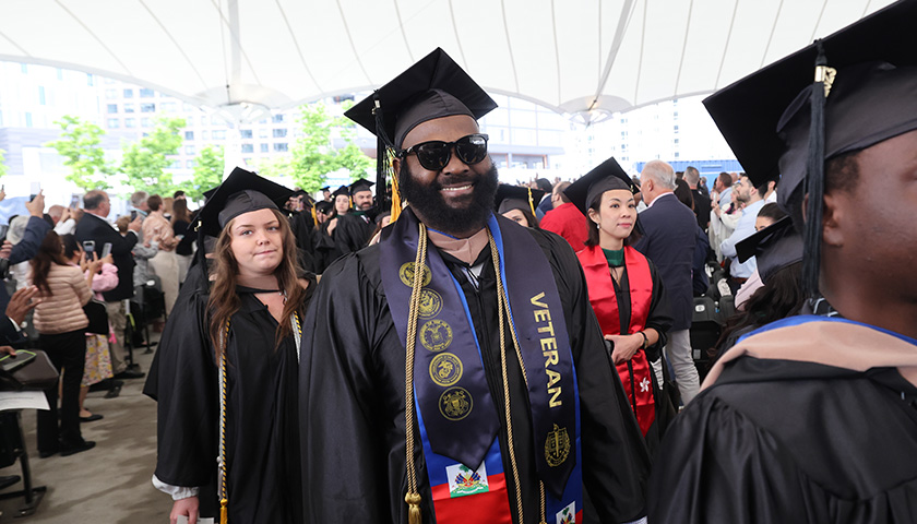 Graduates march at the 2023 Sawyer Business School Commencement