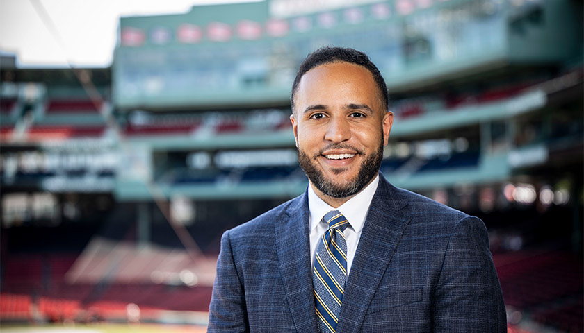 Daveson Perez standing in front of Fenway Park scoreboard