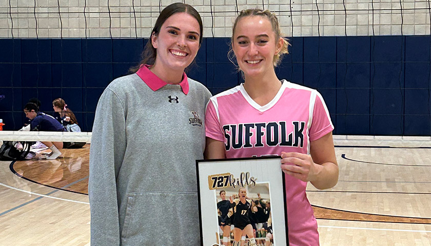 Assistant Coach Hannah Fabiano congratulates McKenna Keowen for breaking her records for kills