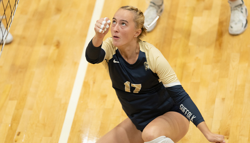 McKenna Keowen drops to her knees to hit a low shot on the volleyball court