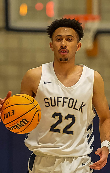 Guard-forward Keenan Robertson dribbles a basketball