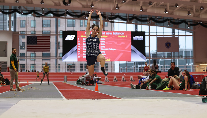 Image of co-captain Nicole DiBenedetto in mid-air during the long jump; she set a school record of 9.32 meters.