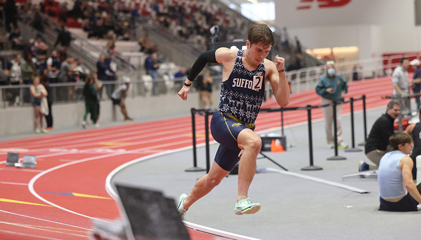 Turner Mitchell rounds the bend during the 200 meter dash. 