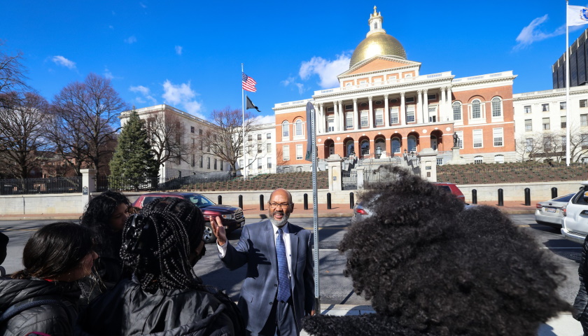 Charles Yancey talks with students across from the Massachusetts State House