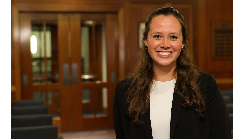 Sally Langan stands in the Suffolk Law mock courtroom